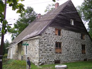 A photograph of the Jean Hasbrouck House where the jenny is located.